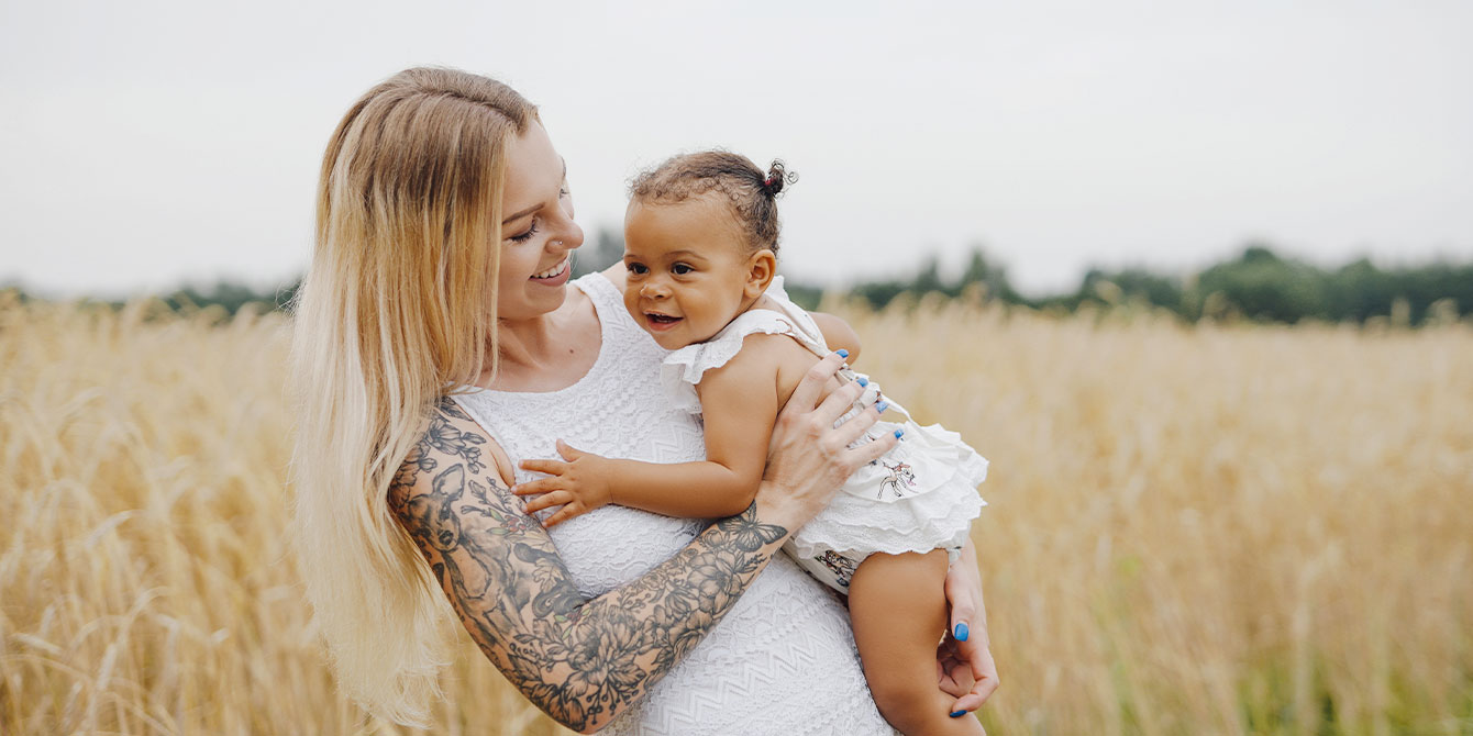 Mom With Tattoos In An Open Field With Her Baby 